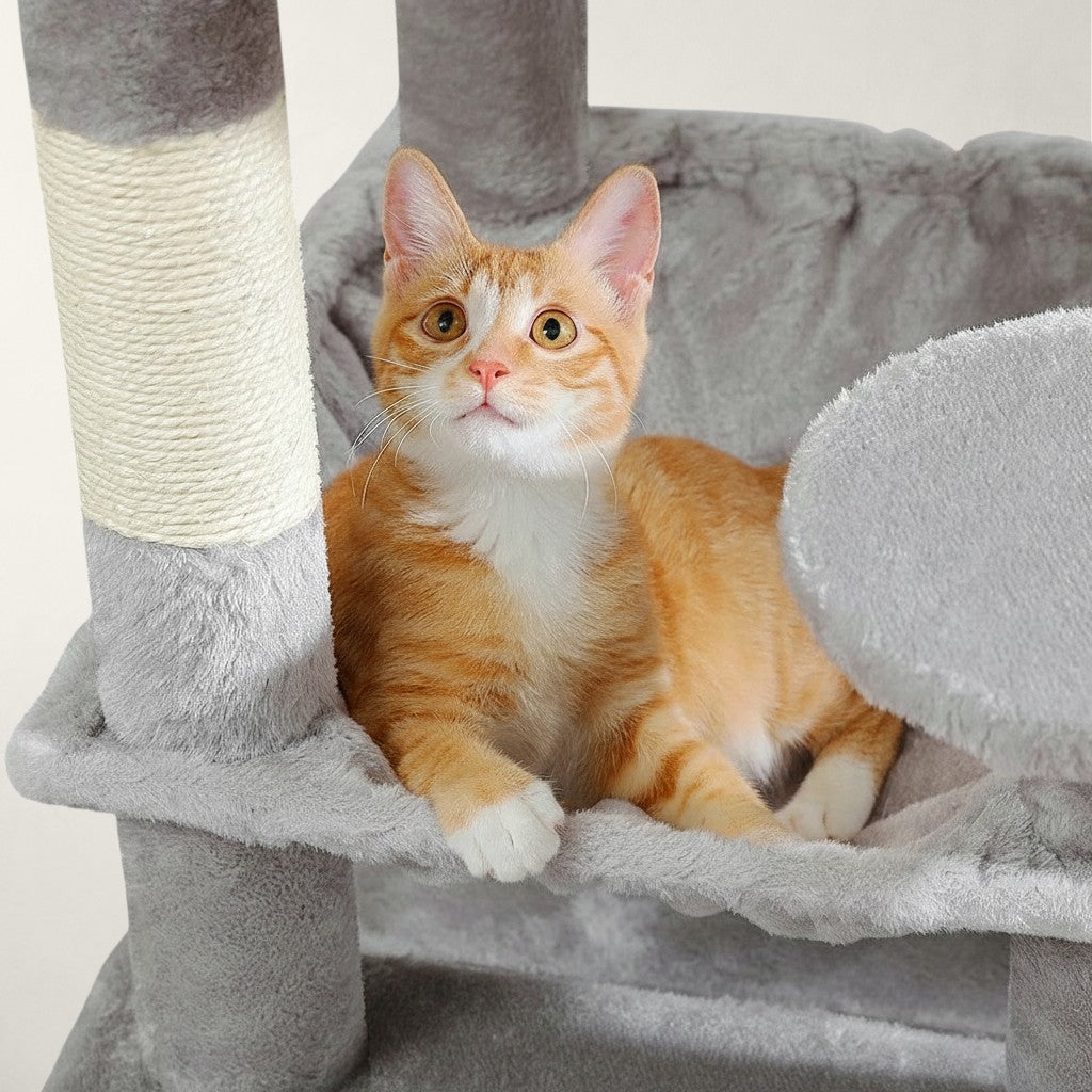 Chat roux allongé dans le hamac gris en fausse fourrure d'un arbre à chat Bofélin avec poteaux en sisal