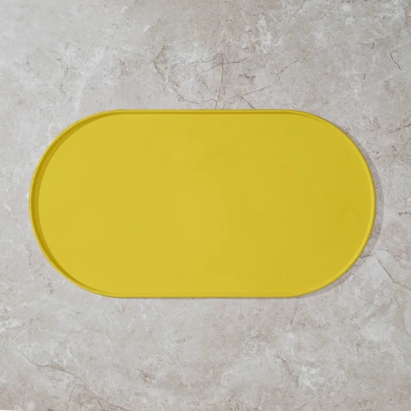 Tapis de gamelle ovale jaune Bofélin en silicone souple antidérapant avec bords relevés pour protéger le sol