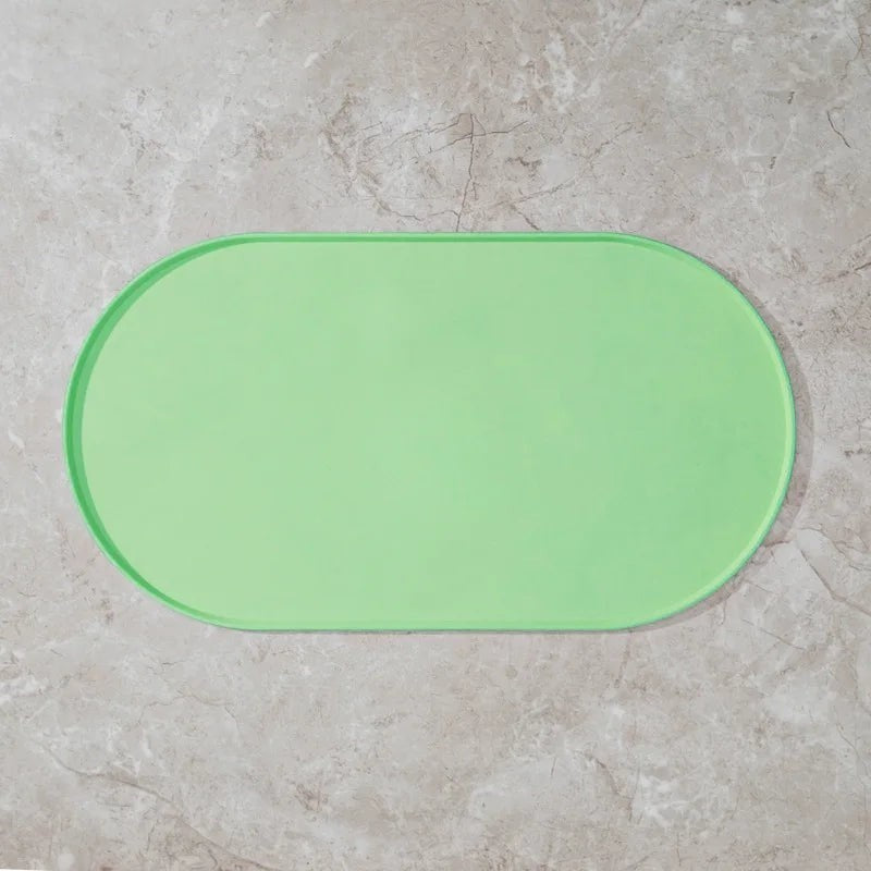Tapis de gamelle ovale Bofélin en silicone vert antidérapant avec bords relevés pour protéger le sol